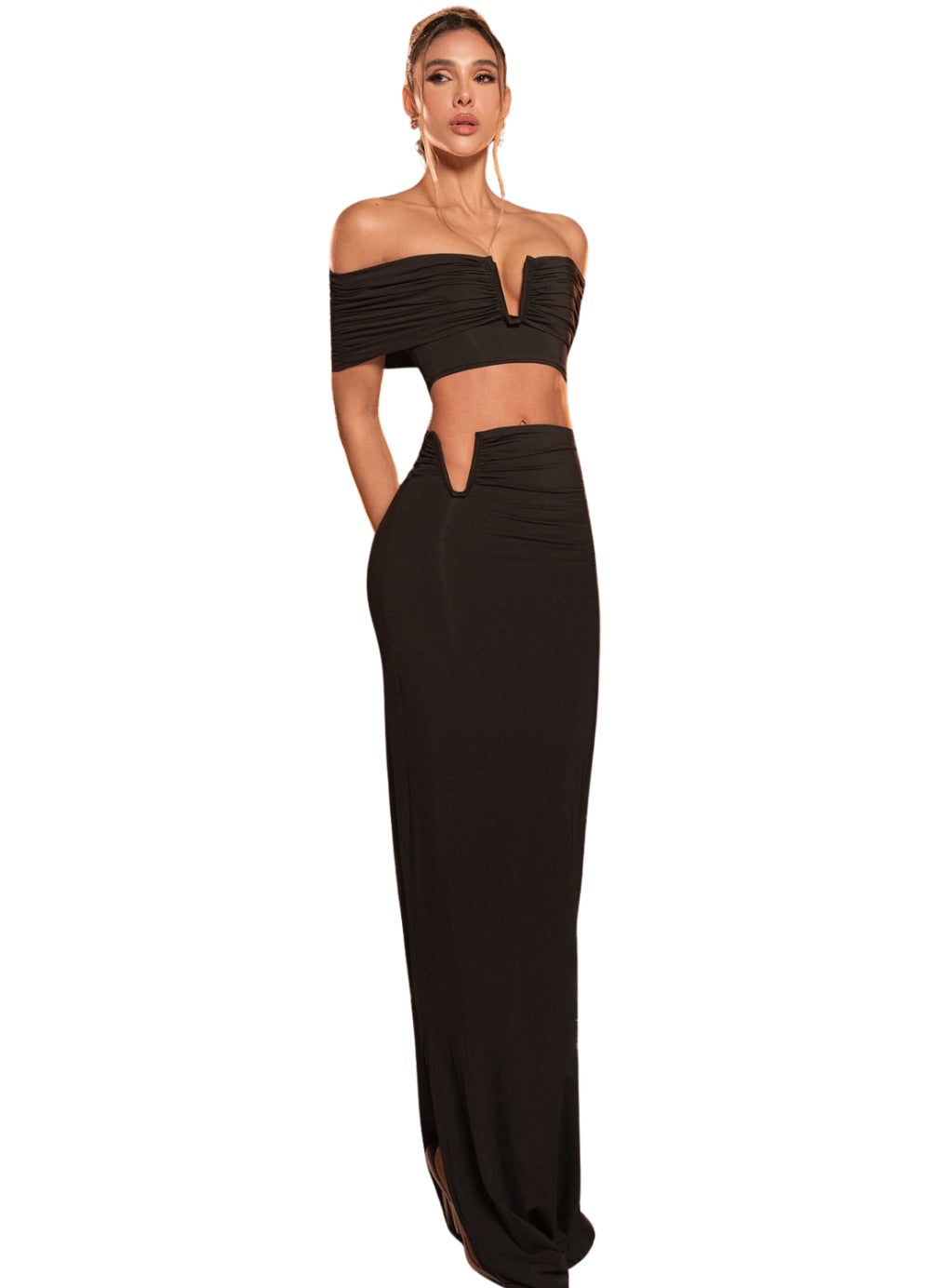 Woman wearing a black off-shoulder top and long skirt set 